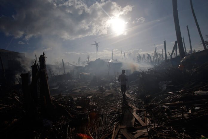 A man walks through an area devastated by Typhoon Haiyan, November 16, 2013. (Reuters/John Javellana)