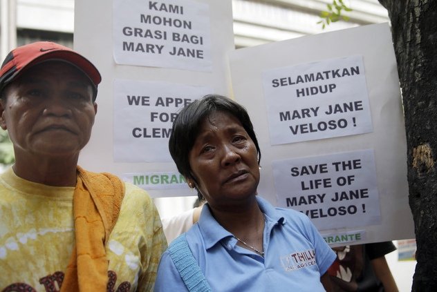 Cesar and Celia Veloso, parents of convicted drug trafficker Mary Jane Fiesta Veloso, wait outside the Indonesian Embassy at the financial district of Makati city, east of Manila, Philippines to deliver an open letter addressed to Indonesian President Joko Widodo Wednesday, April 8, 2015. In the open letter, the Veloso family is asking for clemency to save the life of Mary Jane Fiesta Veloso who was convicted for drug trafficking in Indonesia and is sentenced to be executed after her appeal was rejected by the Indonesian Supreme Court March 26. (AP Photo/Bullit Marquez)